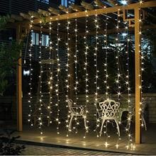 an outdoor gazebo covered in fairy lights and string lights with two chairs on it