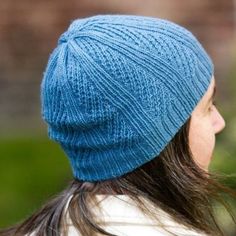 a woman wearing a blue knitted hat