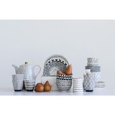 a table topped with bowls and cups filled with fruit next to each other on top of a white counter