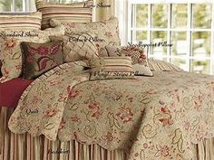 the comforter is made up with many different types of pillows and blankets on it