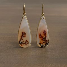 $ 2,400.00 Fiery yet elegant agates teem with branching ember dendrites within subtle gold handmade settings. 18k yellow gold Agates, 14.5mm x 35mm (9/16" x 1 3/8") Earrings hang 2" from the ear Each earring weighs 4.2g Green Sapphire Necklace, Mystic Jewelry, Mystical Jewelry, Cameo Earrings, Jewellery Inspiration, Tourmaline Pendant, Agate Earrings, Dendritic Agate, Tourmaline Necklace