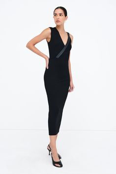 Dress outside the lines with our Carlton Dress, an elegantly unique sheath silhouette. Her asymmetrical design features one wide shoulder and a slender faux leather strap (wide enough to conceal bra straps) that continues down to define her waist. Crafted from structured, mid-stretch European ponte with a hidden side zip for easy on/off. [SPLIT] Astrid is 5'9" (175 cm) tall, wearing size XS. Total length approximately 49.5" (125.5 cm). European Ponte, also known as Punto di Roma (60% Viscose, 30 Chic Evening Bandage Dress With Asymmetrical Neckline, Sleek Bodycon Dress With Asymmetrical Neckline, Modern V-neck Midi Dress For Party, Elegant One Shoulder Midi Dress For Club, Elegant Asymmetrical Midi Dress For Club, Modern Black Midi Dress For Party, Chic Asymmetrical Midi Dress For Club, Club Midi Dress With Asymmetrical Neckline, Elegant Evening Bandage Dress With Asymmetrical Neckline