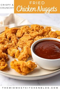 fried chicken nuggets on a white plate with ketchup and dipping sauce