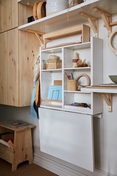 a white shelf with baskets and other items on it