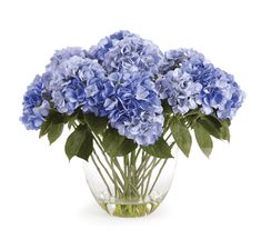 a vase filled with blue flowers on top of a table