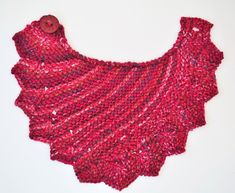 a red knitted shawl with buttons on it