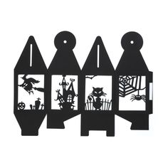 three pieces of paper cut out to look like houses with bats and witches on them