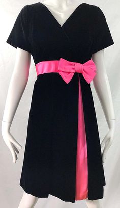 For Sale on 1stDibs - Gorgeous 1950s demi couture black velvet and hot pink silk fit n' flare dress ! Features a tailored bodice with a full skirt. Hot pink bow detail at left Fitted Black Dress With Satin Bow, Black Fitted Dress With Satin Bow, Pink Fitted Velvet Dress, Fitted Black Dress With Sashes, Black Party Dress With Ribbon, Formal Fitted Dress With Ribbon, Fitted Evening Dress With Ribbon, 50s Couture, 1950s Clothes