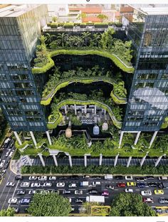 an aerial view of a city with lots of trees and plants growing on the buildings