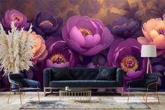 an elegant living room with purple flowers on the wall and blue velvet sofa in front