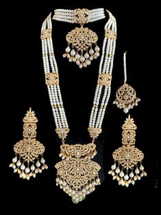 bridal set  includes choker , earrings , jhoomar , tika , ring , bracelet and Rani haar  made using cz stones , shell pearls , beads and gold plating Gold Kundan Sets With Naqshi Detailing, White Kundan Bridal Sets, White Kundan Meenakari Wedding Jewelry, White Kundan Bridal Sets For Marriage, White Kundan Wedding Reception Accessories, Kundan Bridal Sets With Stone Work For Marriage, White Kundan Bridal Accessories With Intricate Design, White Kundan Bridal Sets With Tilla, White Kundan Bridal Sets With Tilla Details