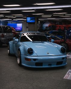 there are many cars that are parked in the parking garage, and one is blue