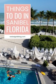 two people are swimming in an outdoor pool near the beach with umbrellas and chairs