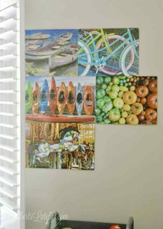 three paintings hanging on the wall above a table with fruit and vegetables in front of them