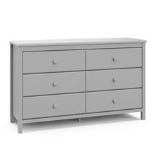 a grey dresser with four drawers and two doors on the bottom drawer, in front of a white background