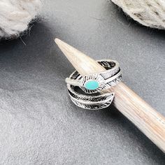 a pair of rings sitting on top of a piece of yarn next to a crochet hook