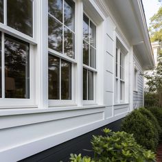 the side of a house with white windows