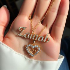 a person holding two personalized necklaces in their hand with the word zamba written on it