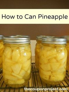 four jars filled with sliced pineapples sitting on top of a metal cooling rack