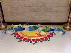 an artistic design on the floor in front of a brick wall with candles and decorations