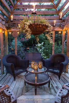 an outdoor living area with wicker furniture and lights