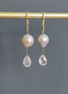 Genuine Freshwater Pearl and Pink Faceted Teardrop Rose Quartz Earrings, 24 K Gold Filled, June Birthstone, Gift for Mother, Wife, Sister. * Material *  24 K Gold Filled, natural stone. Pearls of different shapes on the right and left, respectively, chose a natural one from which the goodness of natural products came out.  Glossy ivory is attractive.  Earring size: 1.85'' (47 mm. ) from top to bottom. *Please add this store as your favorite and visit again! https://www.etsy.com/shop/GlamorousJew Wedding Gemstone Teardrop Earrings, Wedding Teardrop Gemstone Earrings, Briolette Pearl Earrings With Gemstone For Wedding, Wedding Briolette Pearl Earrings With Gemstone, Faceted Teardrop Earrings For Weddings, Briolette Faceted Wedding Earrings, Teardrop Faceted Earrings For Wedding, Wedding Briolette Faceted Earrings, Pink Briolette Jewelry For Wedding