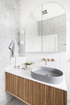 a bathroom with a sink and mirror in it