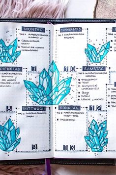 an open planner with blue crystals on it