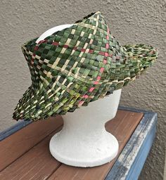 (I'd be happy to check for more accurate postage costs, just send through your delivery address) Art number: 583 color : Green/Nature/Red Measurement: Head circumference : 55 cm Size : S/M height: 8 cm Brim: 6 cm. Material: Harakeke (Maori) / New Zealand flax Unisex Handwoven hat (potae) made from New Zealand flax (harakeke), through the traditional Maori weaving techniques. Some of the flax used has been dyed to give it its color. Every product has been carefully woven. The color may slightly v Handmade Green Bohemian Straw Hat, Traditional Handmade Green Hats, Maori New Zealand, New Zealand Flax, Flax Weaving, Woven Handbags, Green Nature, Weaving Techniques, Auckland