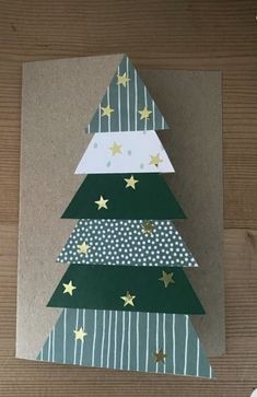 a christmas tree card with gold stars on it