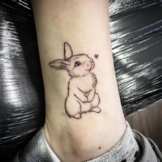 a small rabbit tattoo on the ankle