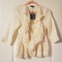 Cream Bobo Jacket With Tie Closure. 100% Cotton. Cream Fabric Has A Very Subtle Checkered Pattern. Lace Along Edges And Bottom Of Jacket. Drawstring Tie Closure With Silver Hardware. Really Beautiful. I Just Bought The Wrong Size And They Wouldn't Let Me Return It. Spring Long Sleeve Outerwear With Ruffles, White Ruffled Cardigan For Spring, Cream Long Sleeve Outerwear With Ruffles, Fitted Cream Outerwear With Ruffles, Fall Daywear Outerwear With Ruffles, Beige Ruffled Outerwear For Spring, Fall Ruffled Outerwear For Daywear, Cream Blazer For Spring Day Out, Spring Cream Blazer For Day Out