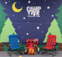 two chairs and a table in front of a camp fire sign with trees on it