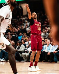 the basketball player is getting ready to shoot the ball in front of the other team