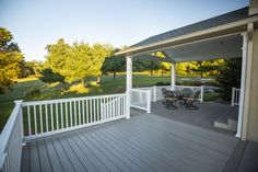 a white porch with two benches on it