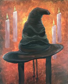 a painting of a witches hat on top of a table with candles in the background