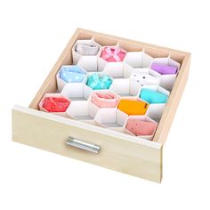 an open wooden box with many different colored items in the bottom drawer and inside compartments