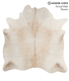 a cowhide rug is shown in white and beige colors, with the words hudson hides actual hide show on it