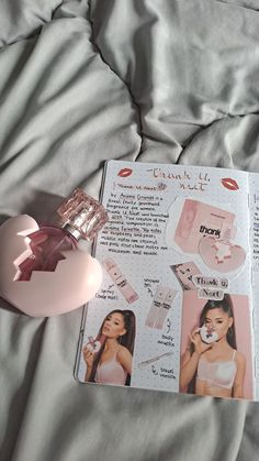 the contents of a pink perfume sitting on top of a bed next to an open magazine