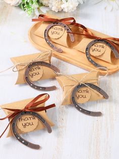 three pieces of brown paper tied to each other with thank you tags attached on them