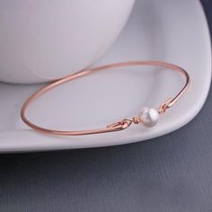 An 8mm Swarovski Pearl is the center of this handmade 14k gold filled bangle. Each bangle is hand formed, then hammered and tumbled for shine and strength. Bracelet available in yellow gold, 14k rose gold-filled, and sterling silver. Wishing Bracelets, Swarovski Pearls Bracelet, Strength Bracelet, Initial Bracelet Gold, Pearl Charm Bracelet, Pearl Bracelet Gold, Stack Bracelets, White Pearl Bracelet, Bracelet Size Chart