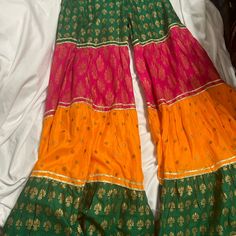 Sharara Ghagra Extra Wide Bottom Trousers In Bright Multi Color, Green, Orange And Pink, Indian Pakistani Wear, This Can Be Paired With Any White Or Black Plain Kurta Kameez Top. Indian Pakistani Traditional Wear Shalwar Kameez. This Listing Is For Trousers Only. Gold Gotta Lace Details Around The Seam. Approximate Size Shown In Picture, It's More Likely To Fit Size Xs- S. If Need More Measurements Please Let Me Know, This Is New Without Tag, Never Worn. Material Is Soft Cotton With Block Print Festive Multicolor Bohemian Bottoms, Festive Bohemian Multicolor Bottoms, Traditional Multicolor Festive Bottoms, Traditional Festive Multicolor Bottoms, Festive Traditional Multicolor Bottoms, Multicolor Bottoms For Festive Summer Occasions, Multicolor Bottoms For Summer Festivities, Multicolor Festive Bottoms For Summer, Summer Multicolor Sharara With Pallu