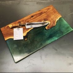 a knife sitting on top of a cutting board with a price tag attached to it