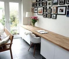 a living room filled with furniture and pictures on the wall