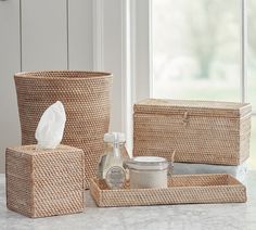 the bathroom accessories are neatly arranged on the counter