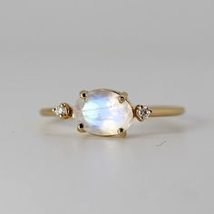 Oval Moonstone Yellow Gold Jewelry, Fine Jewelry Yellow Gold Moonstone Ring, Yellow Gold Moonstone Jewelry With Oval Shape, Fine Jewelry Yellow Gold Oval Cabochon Moonstone Ring, Celestial Moonstone Ring In Yellow Gold, White Oval Moonstone Ring With Celestial Style, Oval Cabochon Moonstone Ring In Yellow Gold, White Oval Moonstone Celestial Ring, White Oval Celestial Moonstone Ring