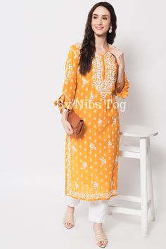 Nibs Tog Mustard Yellow Chikankari Kurti for Women Cotton with Bell Sleeves, Indian Lucknowi Chikankari Kurta Handmade Get comfy with this beautiful Chikankari Kurta for Women, made on super soft cotton fabric. The Kurta has designer Frill Sleeves to make it look for stylish. Grab it soon and check out full details below. Shop More Chikankari outfits by Nibs Tog on our Shop : https://www.etsy.com/in-en/shop/NibsTog Features: Fabric: The beautiful Chikan Kurta is made of Pure Cotton Fabric. The L Orange Bandhani Print Kurta For Eid, Orange Bandhani Kurta For Eid, Eid Orange Kurta With Bandhani Print, Orange Bandhani Print Kurta For Diwali, Orange Kurta With Chikankari Embroidery, Orange Chikankari Embroidered Straight Kurta, Semi-stitched Orange Kurta With Chikankari Embroidery, Orange Straight Kurta With Chikankari Embroidery, Yellow Chikankari Kurti