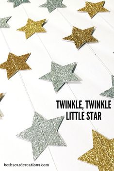 some gold and silver stars are hanging from the ceiling with text overlay that says twinkle,