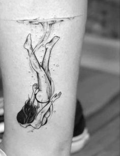 a woman's leg with a tattoo on it