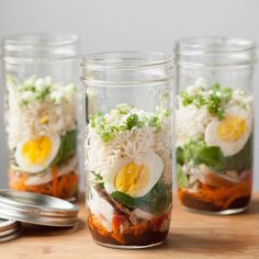 three mason jars filled with food sitting on top of a table